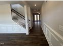 Hallway with trim and beautiful hardwood floors, providing seamless flow and architectural interest at 741 Aristocrat Ln, Knightdale, NC 27545
