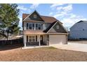 Charming two-story home featuring a well-manicured lawn and attached two-car garage at 89 Bison Ln, Lillington, NC 27546
