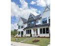 Beautiful white townhouse with stone accents, modern windows, and well-maintained landscaping at 905 Myers Point Dr, Morrisville, NC 27560