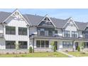 Charming townhouse row with white exteriors, stone accents, and neat landscaping at 905 Myers Point Dr, Morrisville, NC 27560