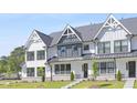 Attractive white townhouses with black-framed windows and well-maintained green lawns at 905 Myers Point Dr, Morrisville, NC 27560