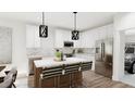 Bright kitchen with stainless appliances, stone countertops, and central island with barstool seating at 905 Myers Point Dr, Morrisville, NC 27560