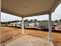 Covered patio view of neighborhood highlighting the new home construction and spacious lot at 97 Willow Cameron Way, Angier, NC 27501