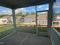 Inviting covered back patio offering an excellent outdoor living space with views of the neighborhood at 97 Willow Cameron Way, Angier, NC 27501