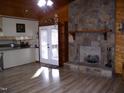 Open-concept living room with a stone fireplace and access to the kitchen at 105 Lake Rd, Henderson, NC 27537