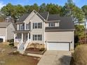 Charming two-story home with a well-maintained lawn, attached garage, and welcoming front porch at 1607 Royal Red Trl, Apex, NC 27502