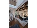 Elegant dining room with coffered ceiling, wood floors, and an open floor plan layout at 1964 Old Byre Way, Apex, NC 27502