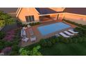 Overhead view of a pool with lounge chairs, fire pit, and a manicured backyard at 214 Reynolds Rd, Raleigh, NC 27609