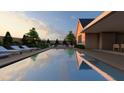 A stunning pool view features clear water, deck chairs, and a serene lounge space at 214 Reynolds Rd, Raleigh, NC 27609