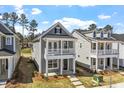 Two-story home with a front porch and balcony, complemented by a well-manicured yard and inviting curb appeal at 272 White Oak Garden Way # 209, Garner, NC 27529