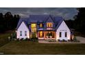 Stunning two-story home with a manicured lawn and inviting front porch seating at 299 Seaforth Landing Dr, Pittsboro, NC 27312
