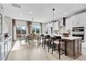 Bright, open kitchen featuring stainless steel appliances, white cabinetry, and a center island with barstool seating at 3024 Freewinds Way # 49, Cary, NC 27519