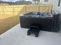 Backyard features a new black hot tub with steps and a wood fence at 322 Oak Branch Trl, Garner, NC 27529