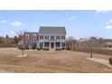 Beautiful two-story home with meticulous landscaping, large lawn, and mature trees at 3808 Hartland Manor Ct, Zebulon, NC 27597