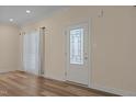 Bright entryway with a decorative glass front door and wood-look flooring, offers a warm welcome at 406 Stewart Town Rd, Lillington, NC 27546