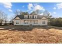 Charming home featuring a welcoming front porch and dormer windows under a blue sky at 406 Stewart Town Rd, Lillington, NC 27546