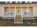 Inviting home exterior with a covered front porch, white railings, and classic design elements at 406 Stewart Town Rd, Lillington, NC 27546