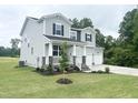 Beautiful home with a spacious lawn, two-car garage, and inviting front porch at 456 Barbour Farm Ln, Four Oaks, NC 27524