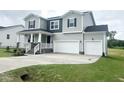 Inviting two-story home with a two-car garage, covered porch, and well-maintained lawn at 456 Barbour Farm Ln, Four Oaks, NC 27524