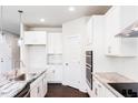 Spacious kitchen with granite countertops, stainless steel appliances, white cabinets, and a center island at 456 Barbour Farm Ln, Four Oaks, NC 27524