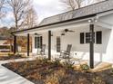 Relaxing porch features ceiling fans, rocking chairs, and a well-manicured landscape at 4664 Quarter Creek Ln, Liberty, NC 27298