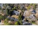 This aerial view showcases the home's setting among mature trees and a lovely neighborhood at 4701 Morehead Dr, Raleigh, NC 27612