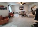 A carpeted living room features comfortable seating and natural light at 5943 River Landings Dr, Raleigh, NC 27616