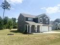 Charming two-story house with a spacious front yard and attractive landscaping at 63 Lynn Crest Way, Four Oaks, NC 27524