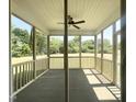 View of screened in porch with ceiling fan and views of the backyard at 63 Lynn Crest Way, Four Oaks, NC 27524