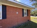 Close-up of brickwork with black shutters and white framed windows at 702 Joyner St, Clayton, NC 27520