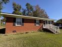 Cozy brick home with inviting entryway steps and tidy landscaping at 702 Joyner St, Clayton, NC 27520