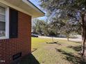 Landscaped yard with mature trees and a charming bird bath at 702 Joyner St, Clayton, NC 27520