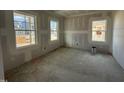 Unfinished bedroom with three windows showcasing the potential for natural light and comfortable living space at 744 Portland Rose Dr, Knightdale, NC 27545