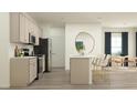 Modern kitchen with stainless steel appliances, an island with barstool seating, and stylish finishes at 77 Sunshine Rd # 3, Kenly, NC 27542