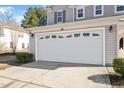 Spacious two-car garage featuring a decorative row of rectangle windows and a concrete driveway at 912 Obsidian Way, Durham, NC 27703