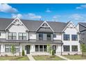 Inviting exteriors of modern townhouses, showcasing clean lines, light colors, and landscaped front yards at 913 Myers Point Dr, Morrisville, NC 27560