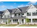Beautiful townhomes with striking white exteriors, complemented by lush green lawns and trimmed landscaping at 913 Myers Point Dr, Morrisville, NC 27560