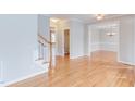 Spacious living room with hardwood floors, staircase, and natural light at 100 Rivercreek Pl, Carrboro, NC 27510