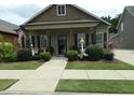 Quaint one-story home featuring a cozy front porch and manicured landscaping, creating inviting curb appeal at 103 Bella Sq Sq, Smithfield, NC 27577