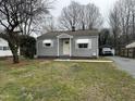 Charming one-story home with light gray siding, awning-covered windows and a simple, inviting front entrance at 104 N Garden Ave, Siler City, NC 27344