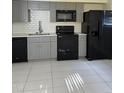 Modern kitchen with gray cabinets, stainless steel appliances, and white subway tile backsplash at 130 S Estes Dr # J1, Chapel Hill, NC 27514