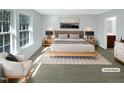 Relaxing bedroom features a large window and a king bed with soft, neutral colored bedding at 1424 Elk Falls Dr, Wendell, NC 27591