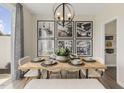 Bright dining area features a wooden table, unique light fixture, and stylish decor at 144 Kobus Ct, Garner, NC 27529