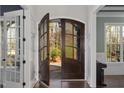 Elegant front door with glass panes letting in natural light to the hardwood floor entryway at 198 Gentry Dr, Pittsboro, NC 27312