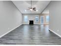 Bright living room featuring a vaulted ceiling, recessed lighting, fireplace, ceiling fan, and hardwood flooring at 201 Silver Creek Dr, Clayton, NC 27520