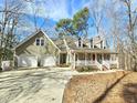 Well-maintained home featuring a covered porch and two-car garage at 2024 Fox Den, Clayton, NC 27527