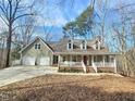 Beautiful home featuring a covered front porch and an attached two-car garage at 2024 Fox Den, Clayton, NC 27527
