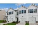 Beautifully designed townhomes boast white siding, black shutters and single car garages at 208 Starlight St, Sanford, NC 27330