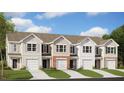 Classic townhomes with brick and neutral siding, each with a single-car garage at 208 Starlight St, Sanford, NC 27330