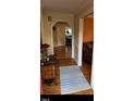 Inviting hallway with hardwood floors, decorative archway, and view to multiple rooms at 2201 Valiant St, Raleigh, NC 27610